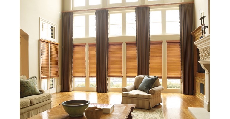 Jacksonville great room with wooden blinds and floor to ceiling drapes.